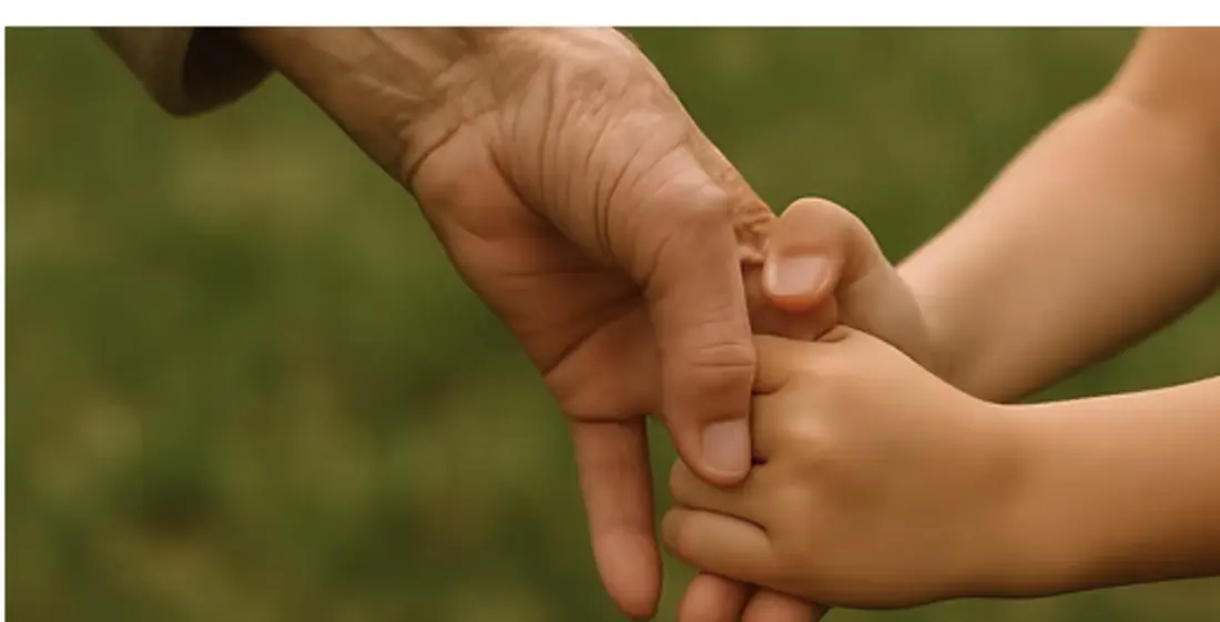 An adult and child holding hands